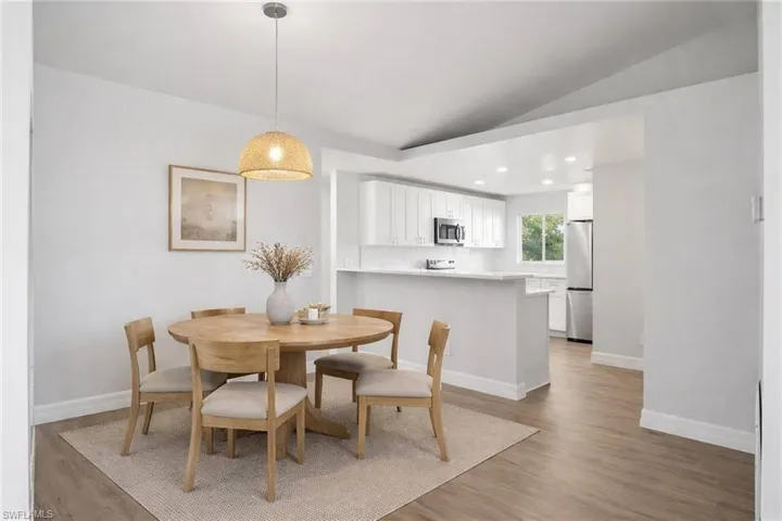 Dining room featuring lofted ceiling, recessed lighting, and light wood-style floors