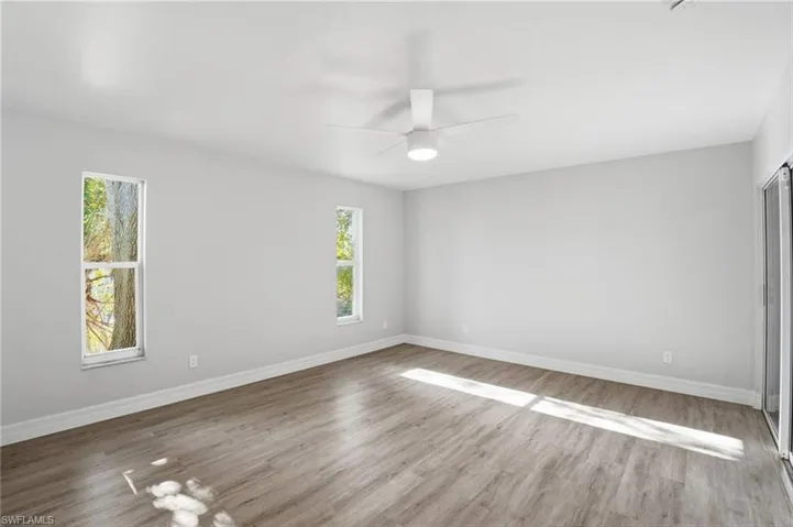 Unfurnished room featuring light wood-style floors and ceiling fan