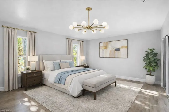 Bedroom with a chandelier and wood finished floors