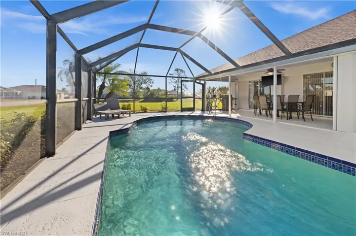 View of pool featuring ceiling fan, a lanai, and a patio