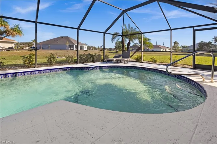 View of swimming pool with a lanai, a patio area, and a yard