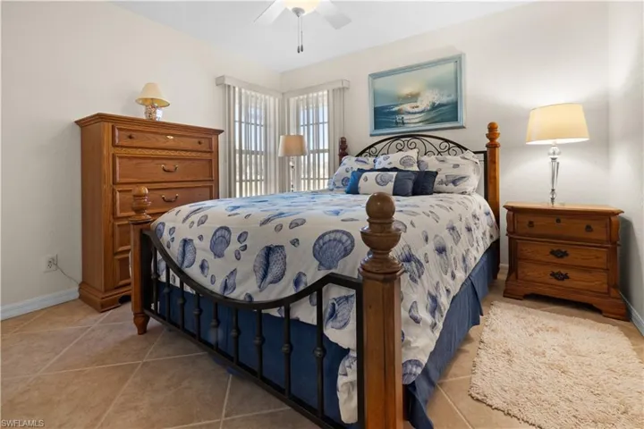 Bedroom with ceiling fan and light tile patterned floors