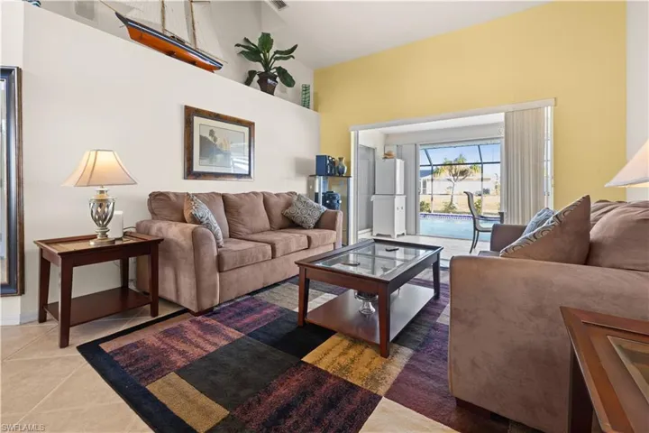 Tiled living room featuring a towering ceiling