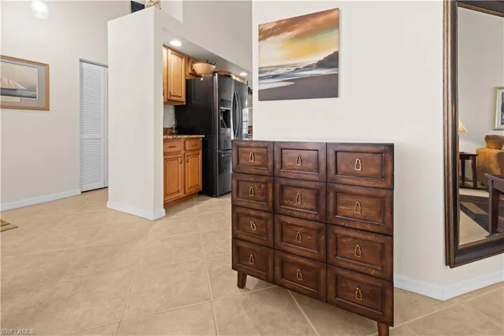 Kitchen with stainless steel fridge with ice dispenser and light tile patterned floors