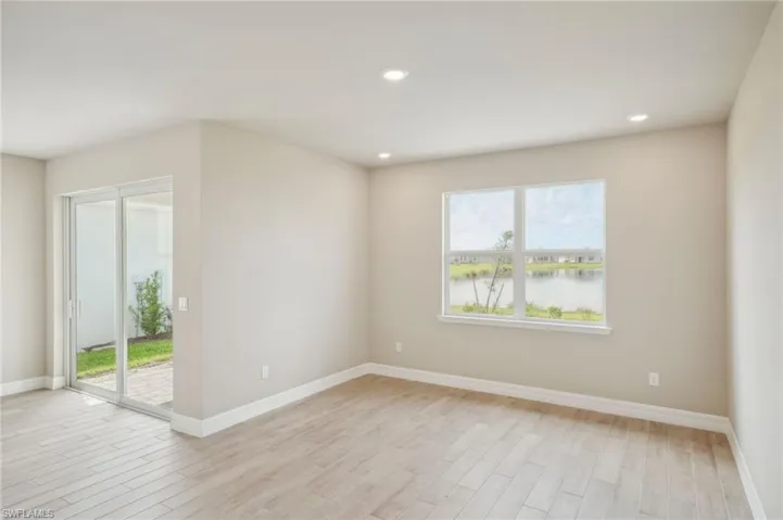 Spare room featuring a water view and light hardwood / wood-style flooring