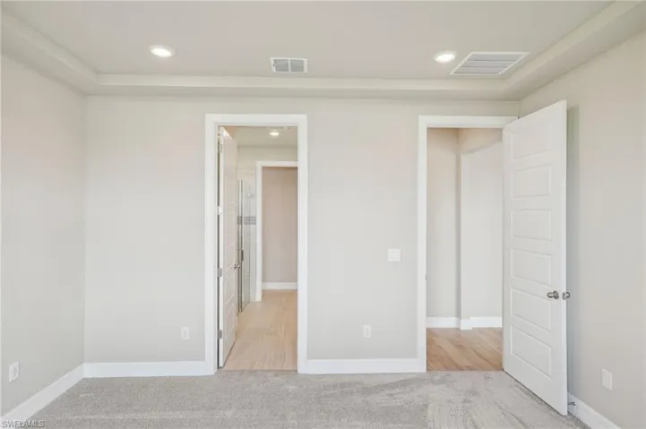 Unfurnished bedroom with light carpet