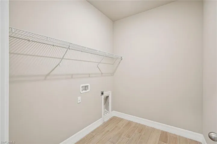 Laundry area featuring washer hookup, hookup for an electric dryer, and hardwood / wood-style floors