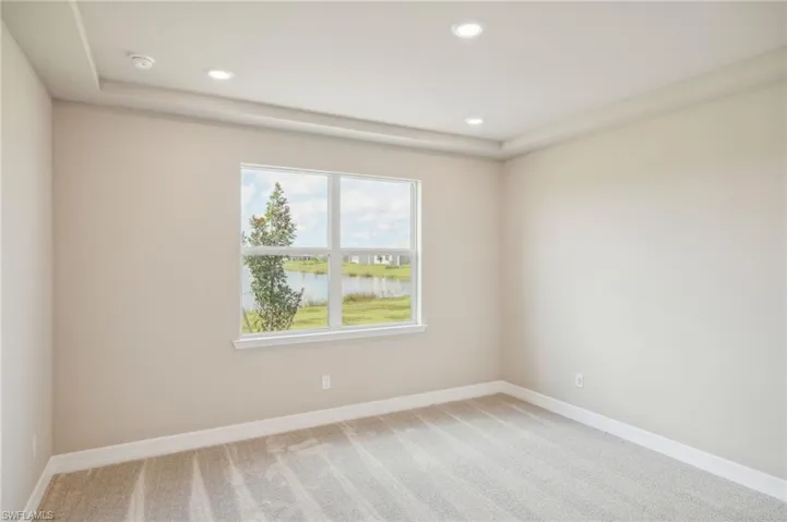 Unfurnished room with carpet floors and a water view