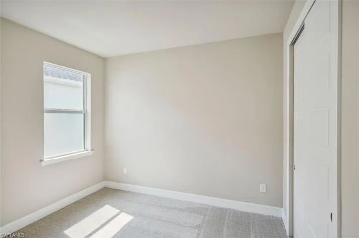 Unfurnished bedroom with carpet and a closet