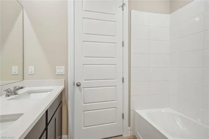 Bathroom with shower / washtub combination and vanity