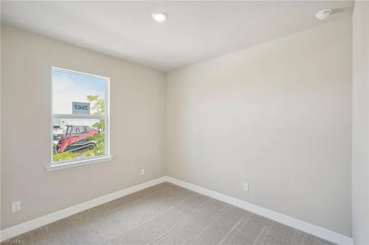 Spare room featuring carpet flooring and plenty of natural light