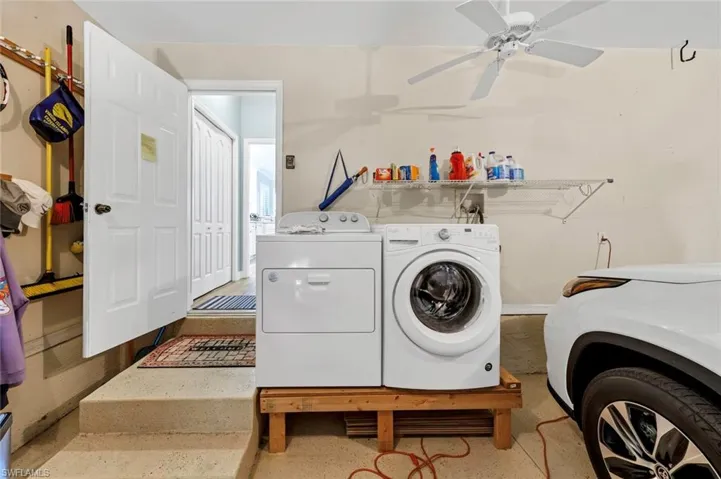 Clothes washing area featuring ceiling fan and washing machine and clothes dryer