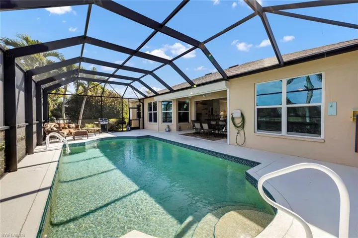 View of swimming pool with a lanai and a patio area