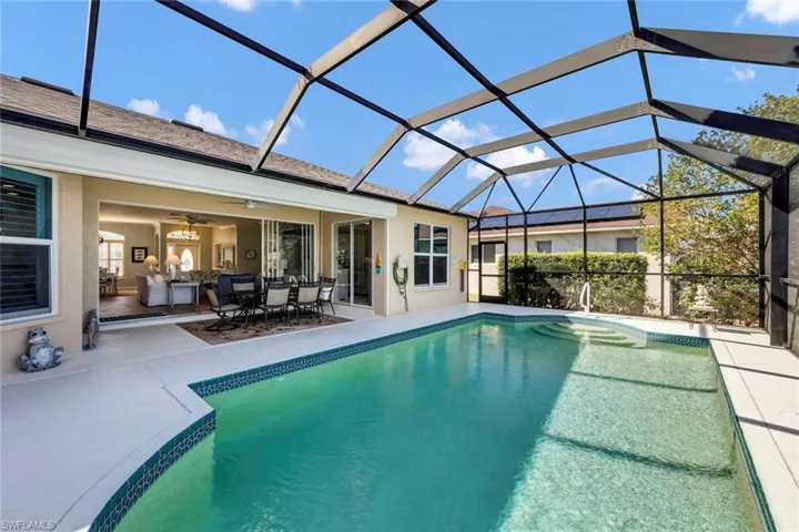 View of pool with ceiling fan, a lanai, and a patio area