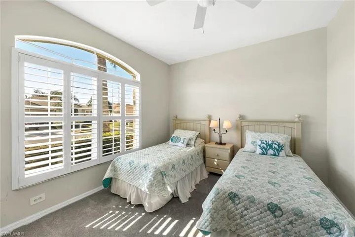 Carpeted bedroom with ceiling fan
