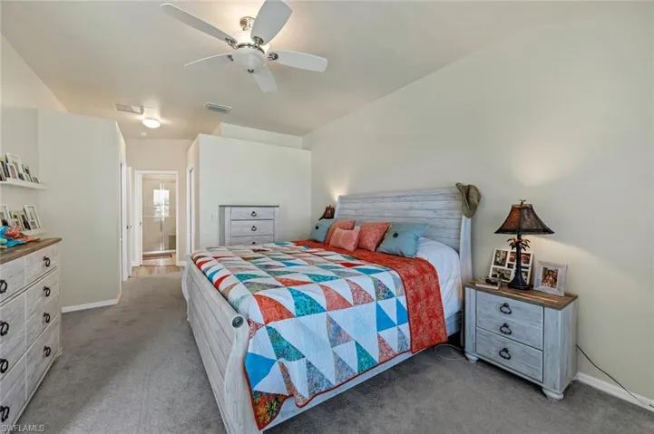 Bedroom featuring ceiling fan and light carpet