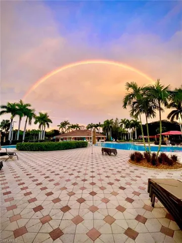 Pool at dusk featuring a patio area