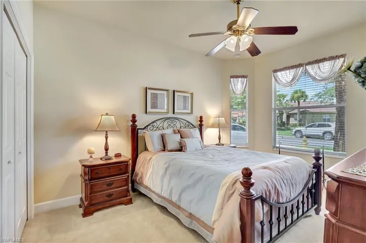 Carpeted bedroom featuring a closet and ceiling fan