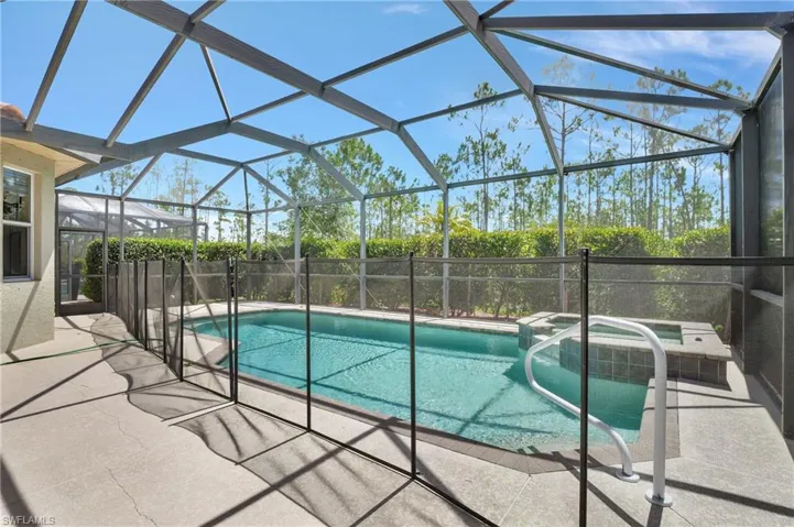 View of pool featuring an in ground hot tub, a patio, and a lanai