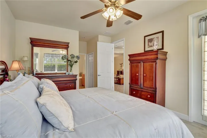 Carpeted bedroom featuring ceiling fan