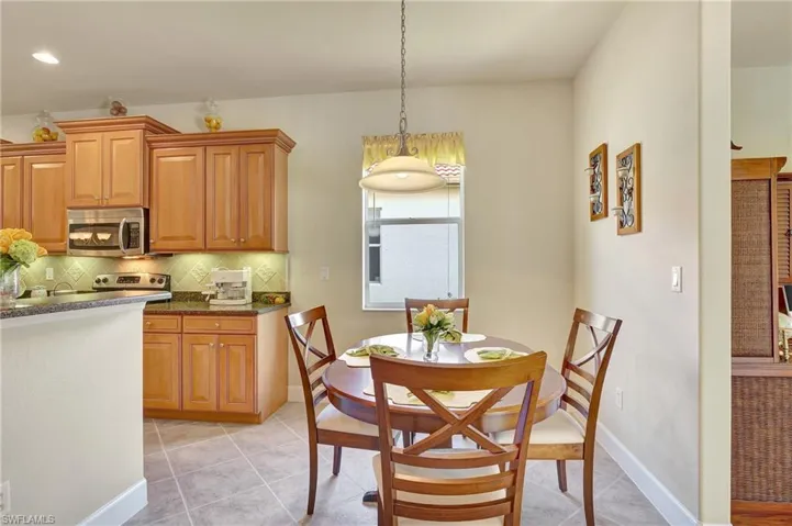 Dining space with light tile patterned flooring