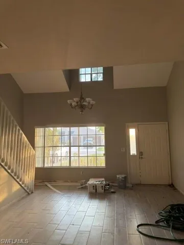 Spacious entry area with soaring ceilings and an elegant chandelier