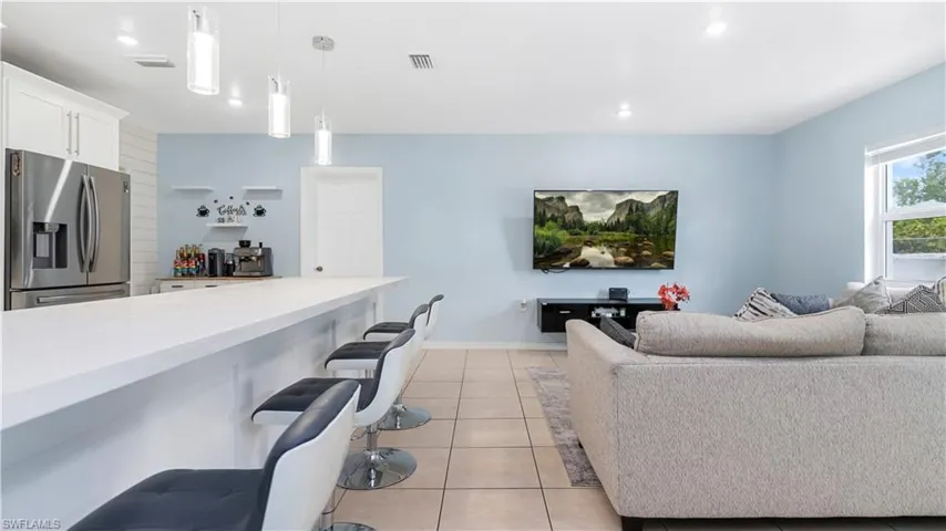 Tiled living room featuring indoor bar