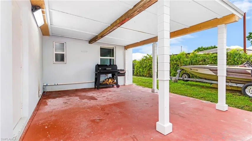 View of patio with a grill