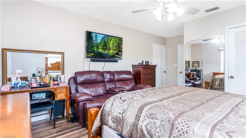 Bedroom featuring ceiling fan, a closet, and hardwood / wood-style floors