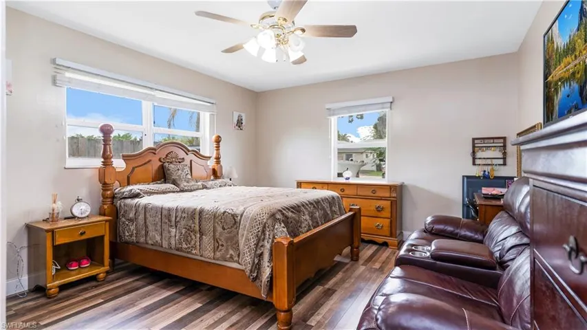 Bedroom with dark wood-type flooring and ceiling fan
