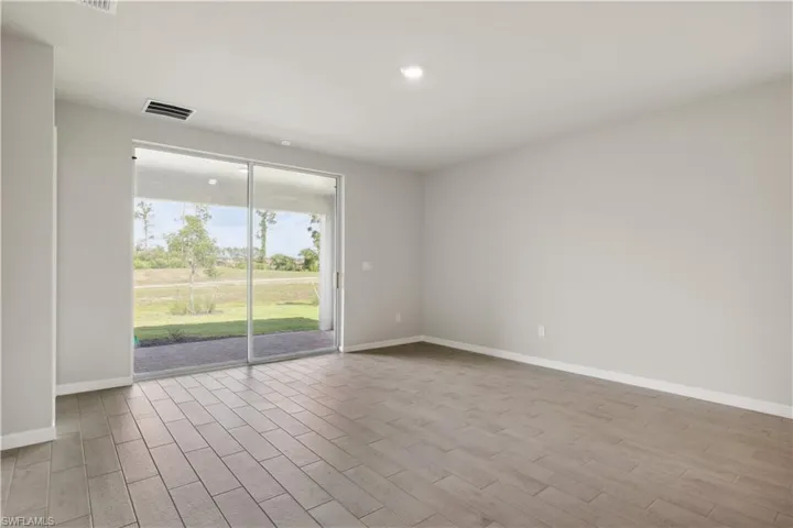 Empty room with light hardwood / wood-style floors