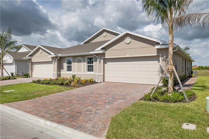 Single story home with a garage and a front yard