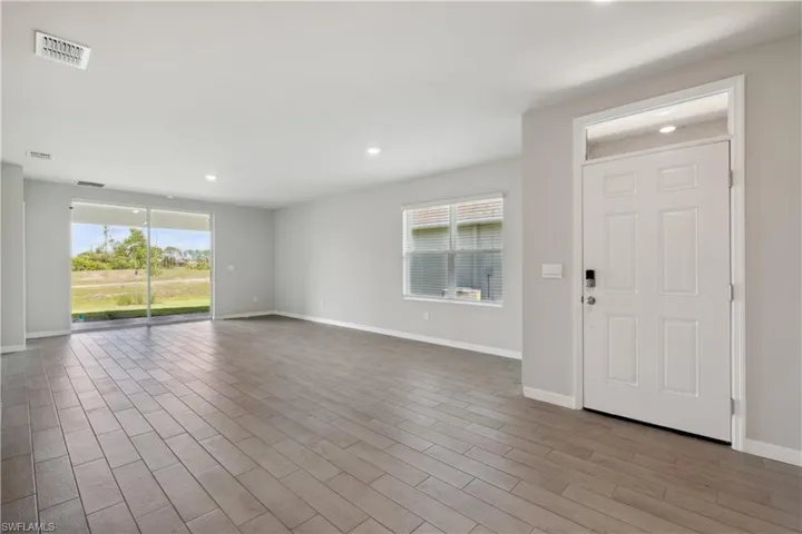 Empty room with hardwood / wood-style flooring
