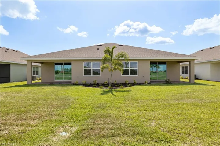 Back of house featuring a lawn