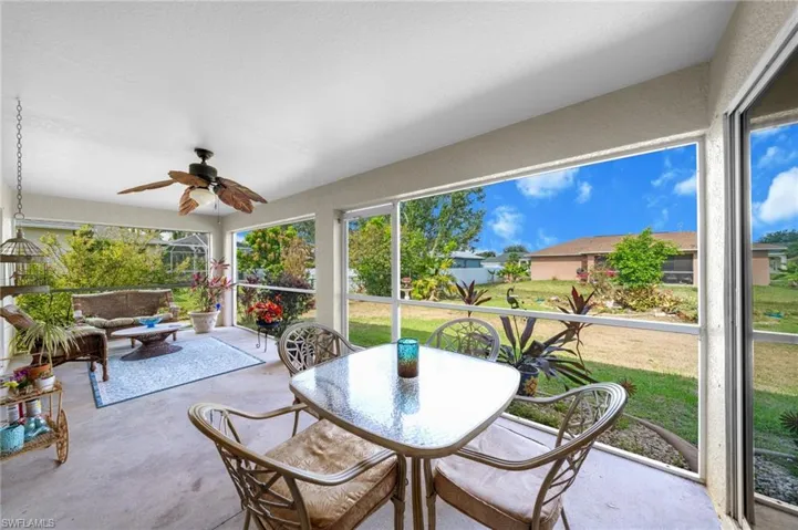Sunroom / solarium featuring ceiling fan, finished concrete flooring, and healthy amount of natural light