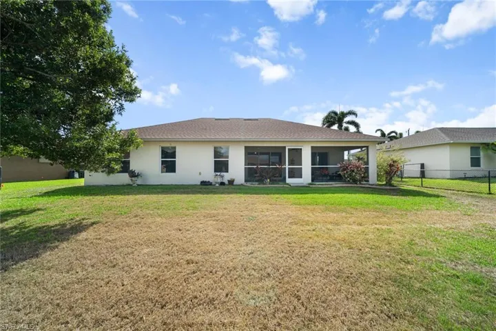 Rear view of property with stucco siding