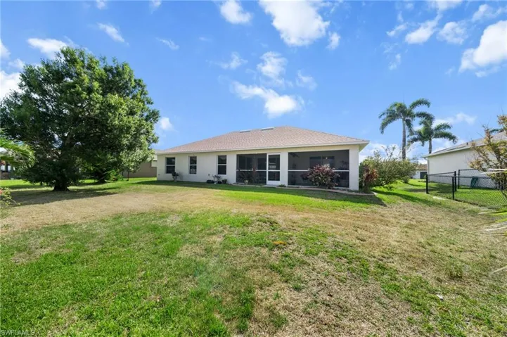 Rear view of property with a sunroom and stucco siding