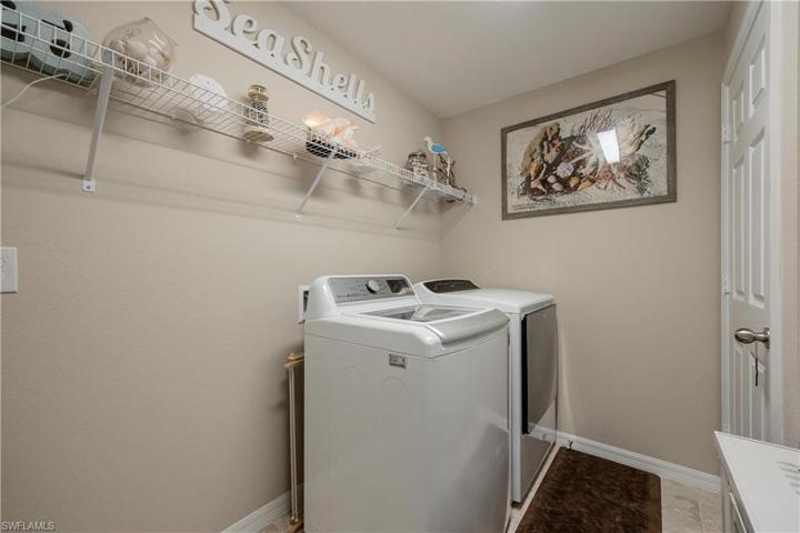 Inside Laundry room w/ washer, dryer, shelving, and an additional closet.