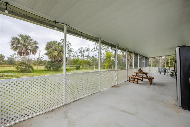 Screened back porch entire length of back of home.