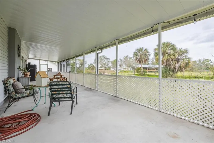 Screened back porch entire length of back of home.