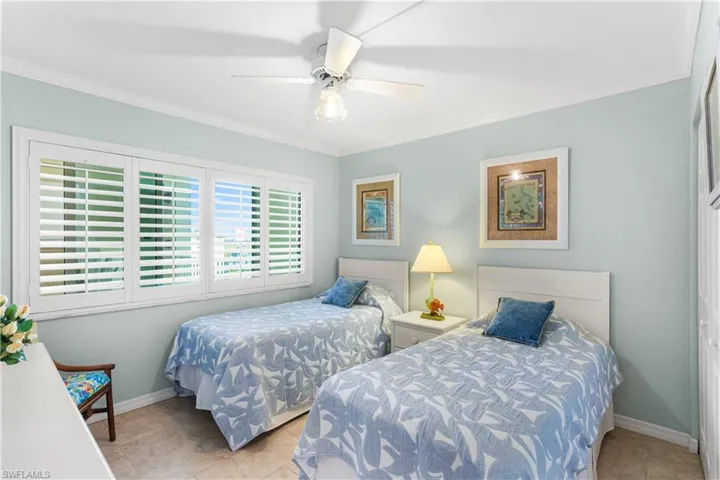 Spacious Guest bedroom with plantation shutters.