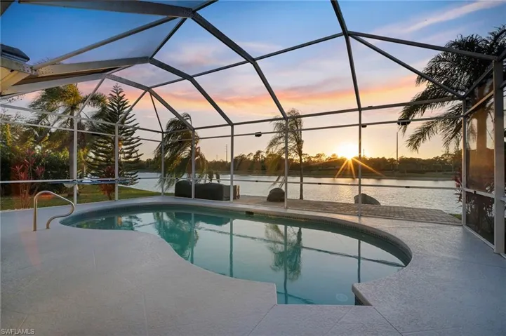 Outdoor pool featuring a sunroom and a lanai