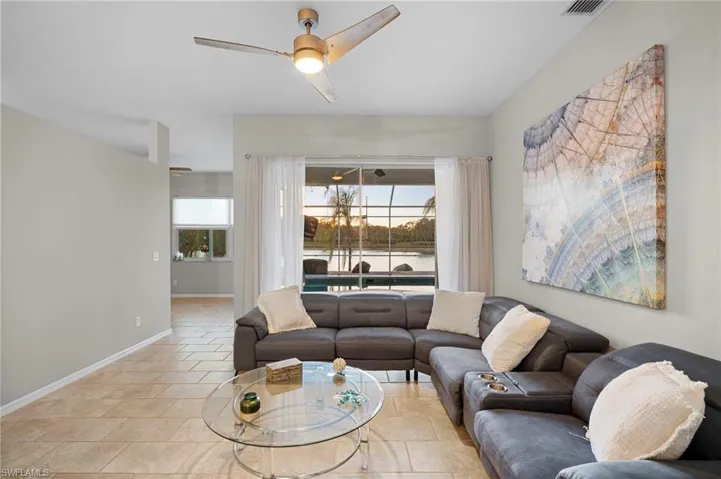 Living room with a ceiling fan and baseboards