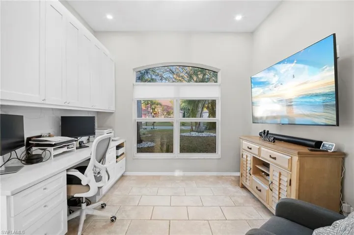 Home office featuring light tile patterned floors, recessed lighting, and built in study area