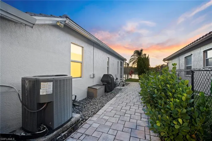 Fenced backyard featuring a patio and a grill