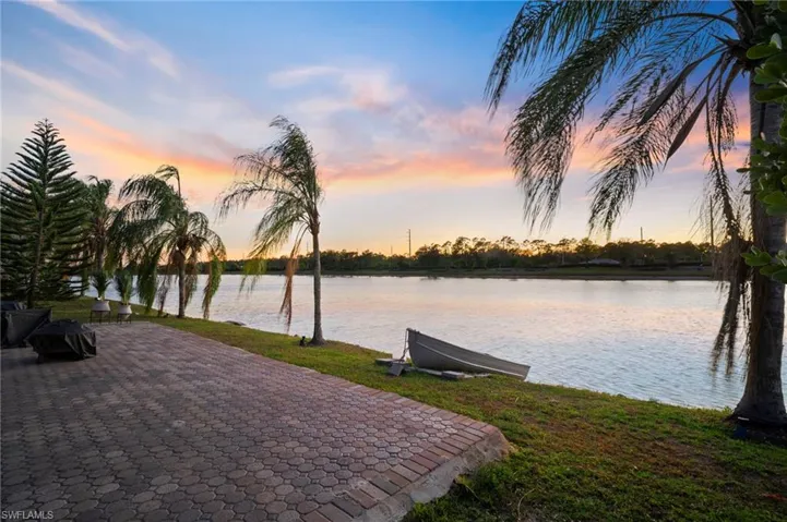 Dock area featuring a patio, a water view, and a yard