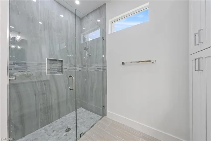 Bathroom featuring tile patterned flooring and an enclosed shower