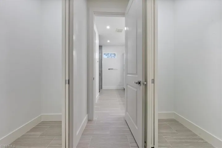 Corridor with light tile patterned floors