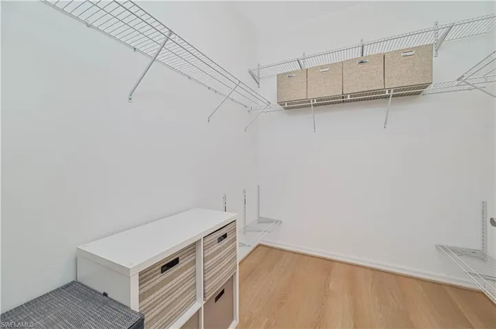 Spacious closet featuring hardwood / wood-style floors