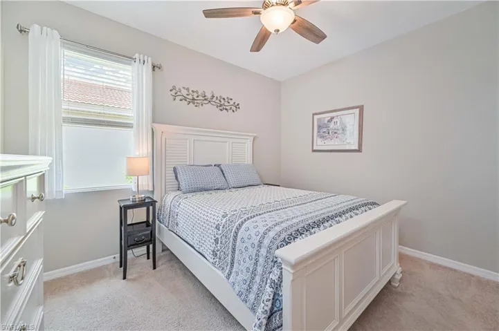 Bedroom featuring ceiling fan and light colored carpet